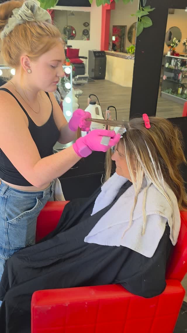 Stylist applying a brow and lash treatment to a client