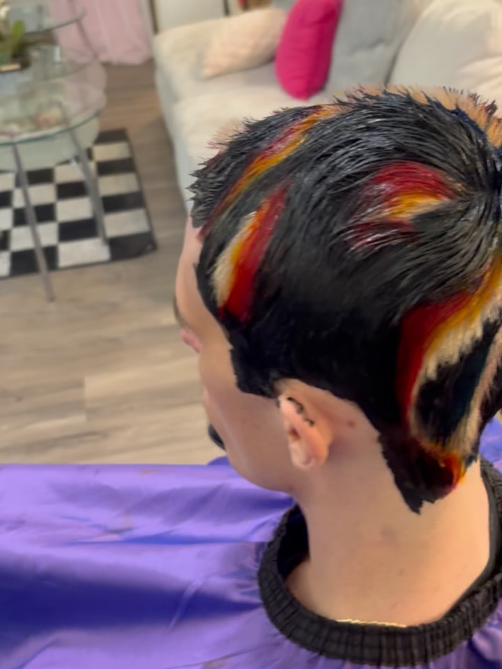Short dark mens cut with a vivid red and orange colour panel
