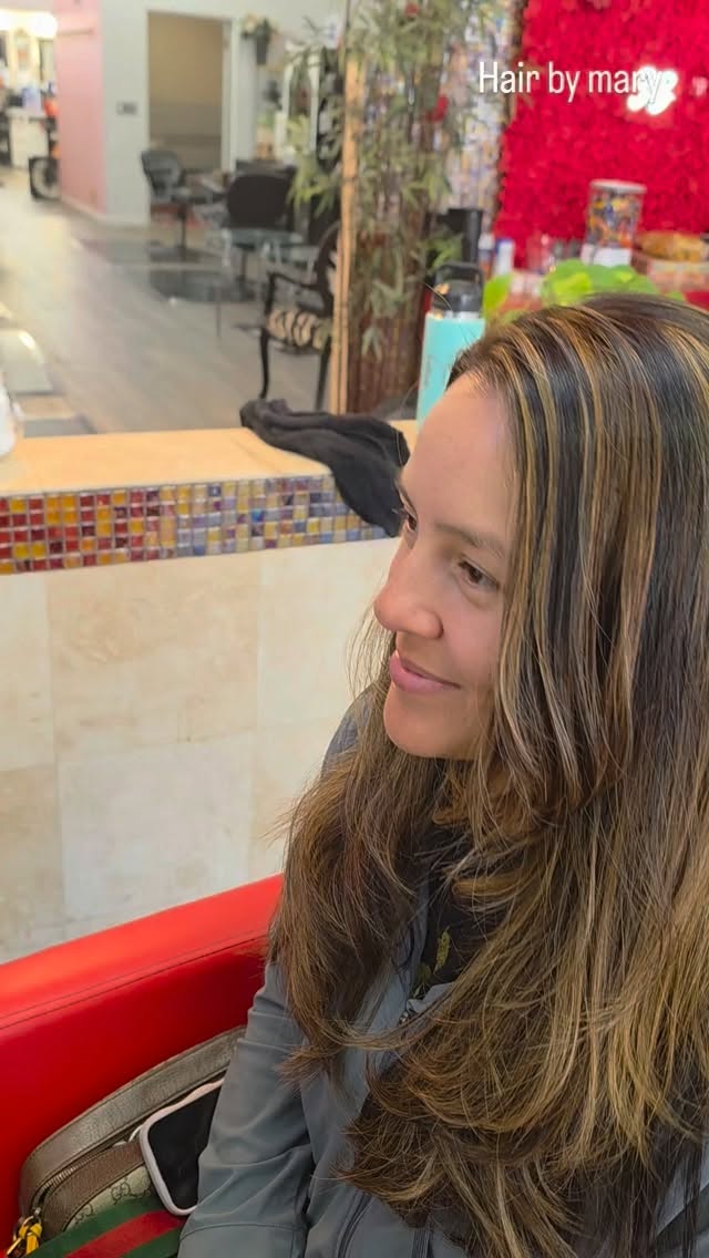 Long brunette balayage on a smiling client, hair by Mary