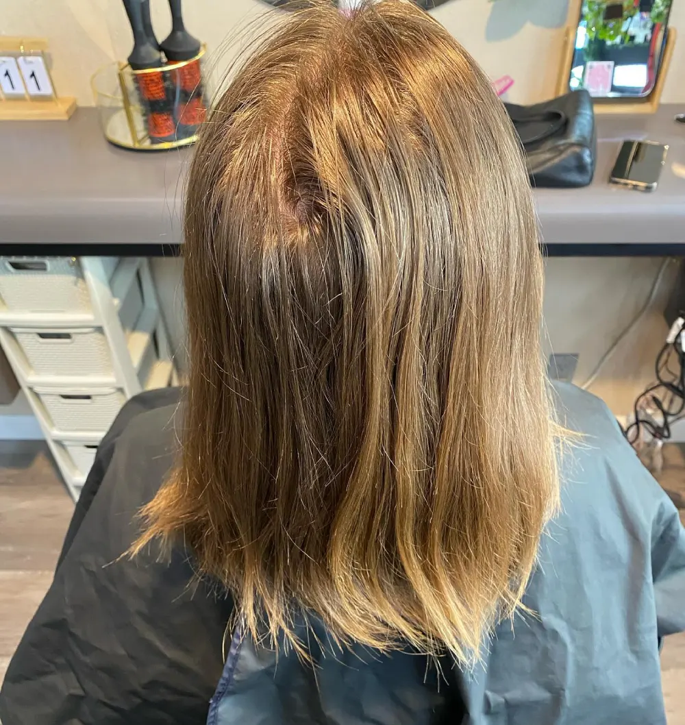 Shoulder-length blonde balayage, back view